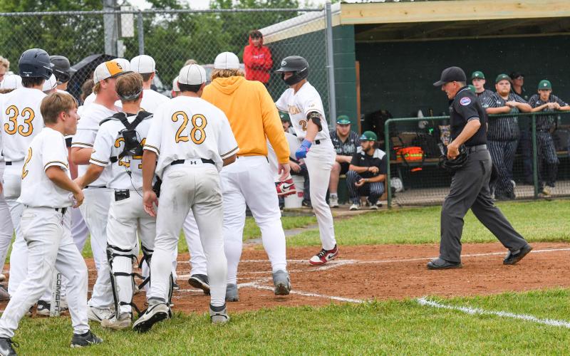 SHOT HEARD ‘ROUND THE WORLD. Raiden Redd is pictured rushing home towards his teammates after a grand slam. His moon shot across the fence tied the score 5-5 for Sullivan in the quarterfinal. It ignited the Eagles to score six more runs, bouncing Perryville. Photo by Extra Innings Photography Article Image Alt Text