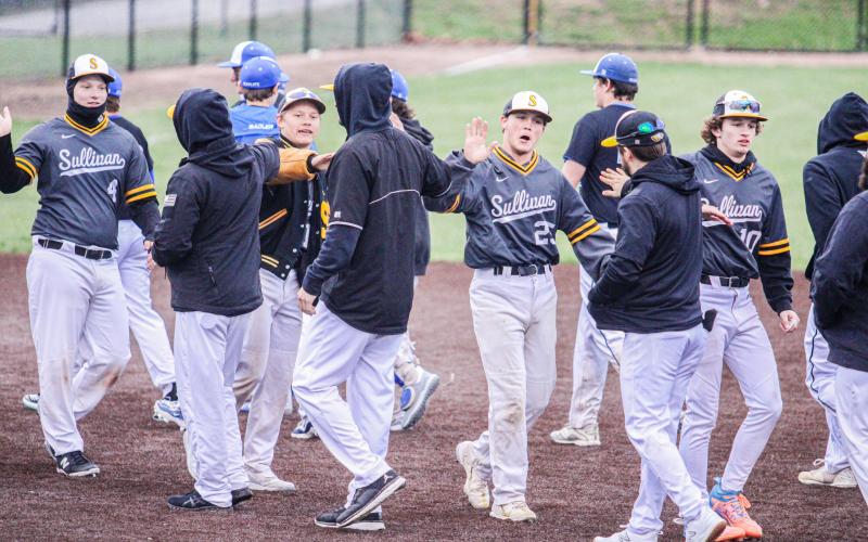 GOOD JOB. The Eagles high-five each other after stomping out Hermann 11-1 on Tuesday, Apr. 2. Photo by Wyatt Hardy Article Image Alt Text