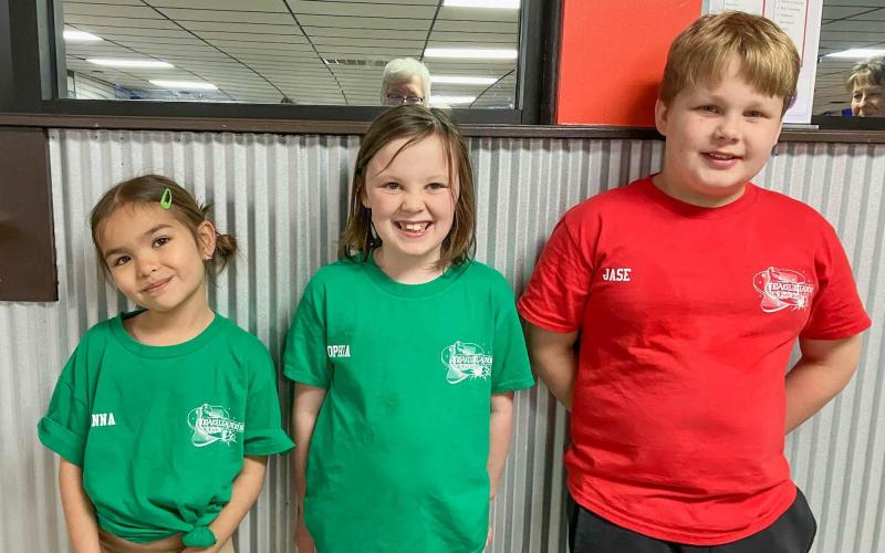 LIFE IN THE FAST LANE. Pictured from left to right are McKenna Silesky and Sophia Kosark of the Green Kittens peewees team, then Jase Ayers of the Deathly Hallows bantam squad. Submitted photo Article Image Alt Text