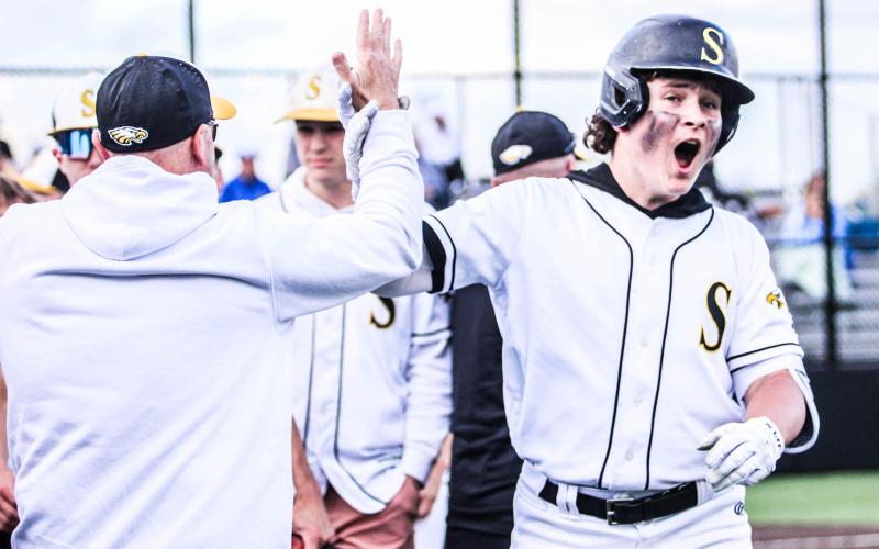 ONE FOR THE BOOKS. Chase Blue (right) high-fives assistant coach Brian Immekus (left) after hitting a home run against Borgia on Apr. 11. Blue became the first Eagle to record a dinger at Sullivan Bank Ballpark since Cody McKinney in 2017. Photo by Wyatt Hardy Article Image Alt Text