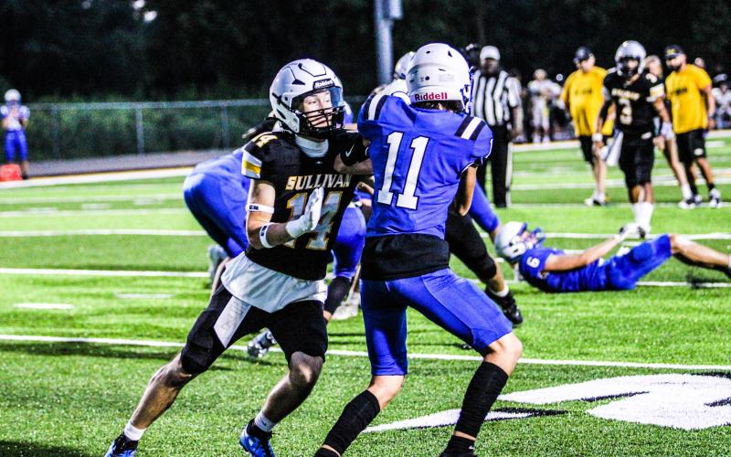 SETH VALLEY (14) blocks a Jefferson defender. Photo by Wyatt Hardy Article Image Alt Text