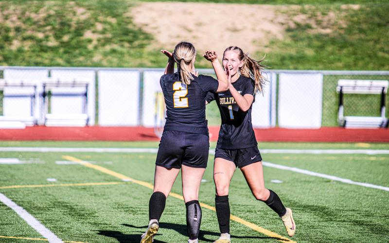 CELEBRATION. Cambria Pohlman (1) high-fives Molly Lohden (2) for her goal. Photo by Wyatt Hardy Article Image Alt Text