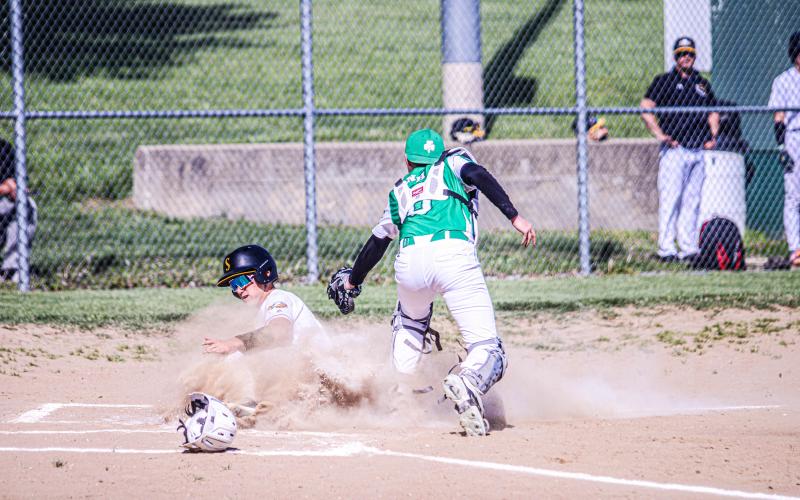 SURFIN’ THROUGH DIRT. Gavin Schmidt slid deep into the dirt for home plate to mark Sullivan’s first score of fourteen against New Haven. Photo by Wyatt Hardy Article Image Alt Text
