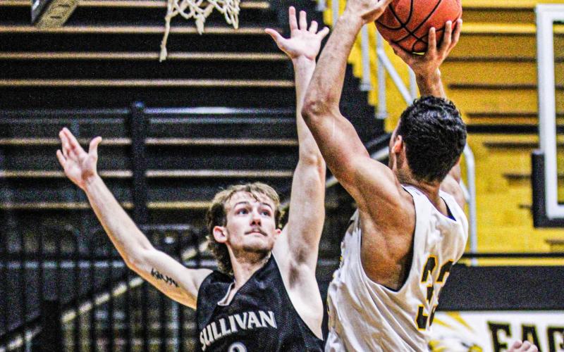 BLOCK CITY. Head coach Kobe Wands is training the Eagles to “lock in on the defensive side of the court.” Pictured is senior Seth Valley (3) attempting to block junior Cameron York (33). Photo by Wyatt Hardy Article Image Alt Text