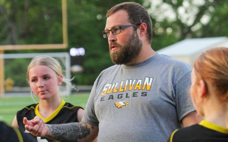 MATT O'DELL is pictured huddled with the junior varsity Lady Eagles. Photo by Wyatt Hardy Article Image Alt Text