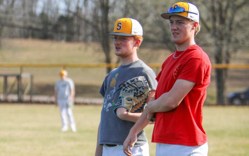 GAWER BRO POWER. Brody Gawer (left) stands alongside his brother Drake (right) on first base. Photo by Wyatt Hardy Article Image Alt Text