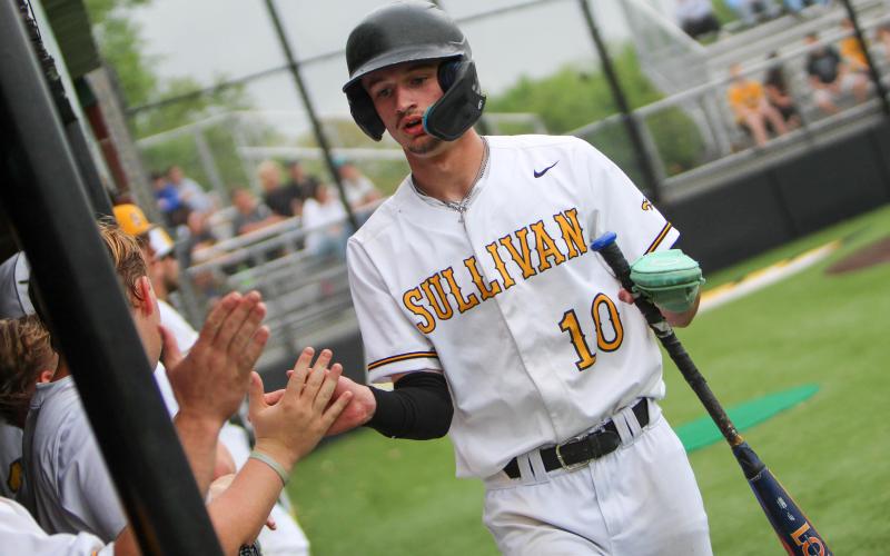 WARM WELCOME HOME. Landen Doza returns to the dugout after scoring. Photo by Wyatt Hardy Article Image Alt Text