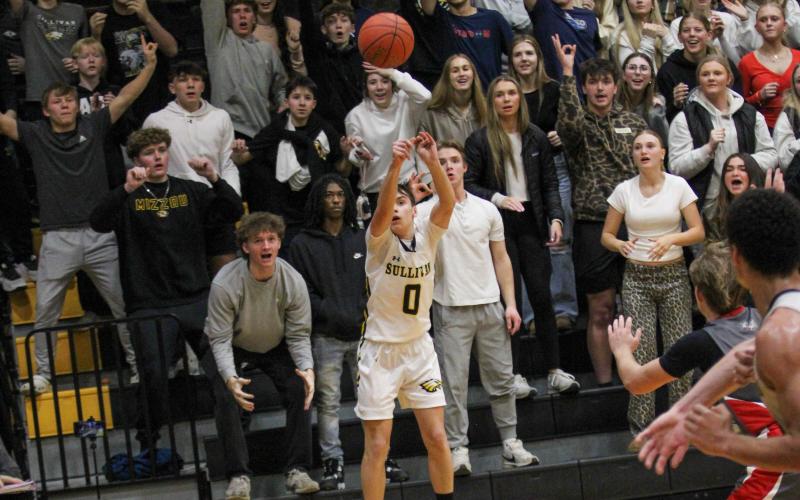‘HE’S A FRESHMAN,’ the Pep Club chanted every time Jared Toews swished in a three from downtown. Photo by Wyatt Hardy Article Image Alt Text