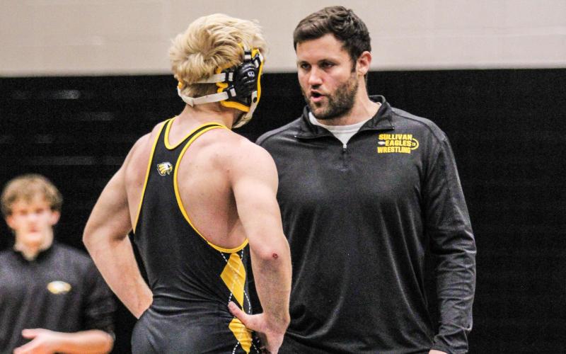 THE ART OF WAR. Head coach Carl Lawrence (right) advises Austin Ray (left) before returning to battle after the medical timeout. Photo by Wyatt Hardy Article Image Alt Text