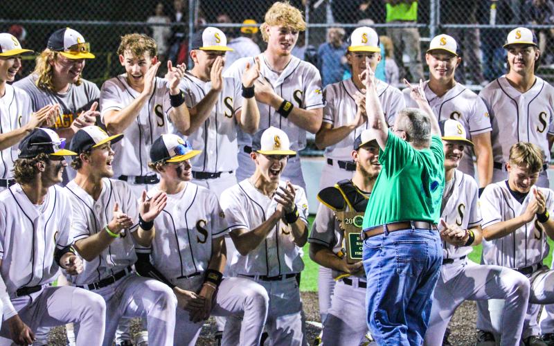 ROCK ON. Diehard Eagles fan Matt Doza celebrates with the baseball players after the district championship. Photo by Wyatt Hardy Article Image Alt Text