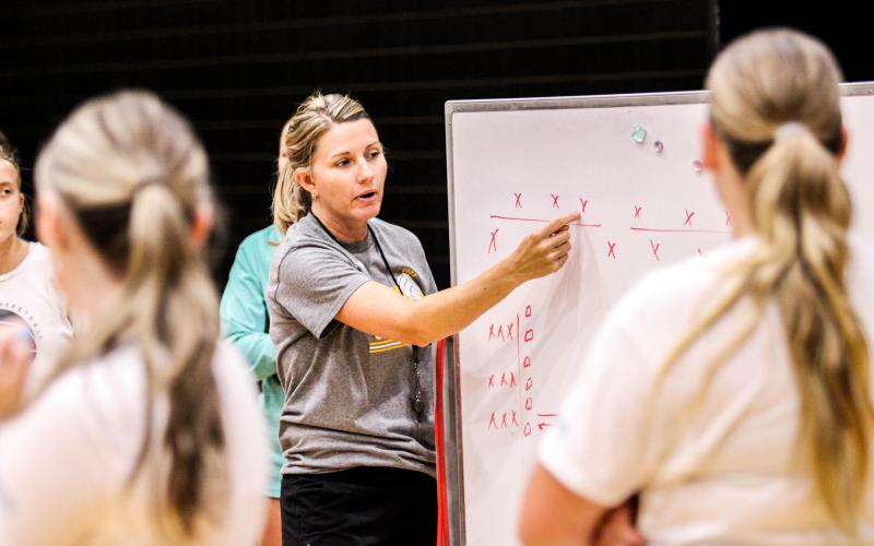 Xs AND Os. Volleyball head coach Sarah Rochleau demonstrated a workout drill she marked up at practice. Every year, Rochleau creates a routine inspired by one of her seniors. This time, she based the drill on Kelsie Hansel, with her FFA roots. The Lady Eagles split into two groups, competing to see who could finish it the fastest. Photo by Wyatt Hardy Article Image Alt Text