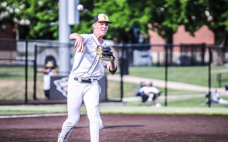 DRAKE GAWER throws from the mound to first base in an attempt to get a runner out. Photo by Wyatt Hardy Article Image Alt Text