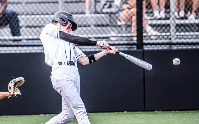 NOLAN ULRICH launches a big shot at bat to ram through MICDS on the field. Photo by Wyatt Hardy Article Image Alt Text