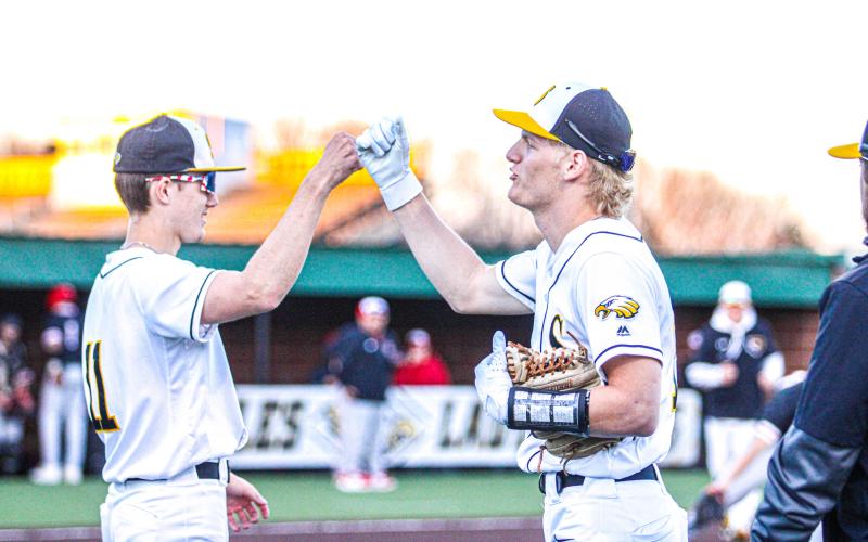 END ON A BANG. Seniors Gavin Schmidt (left), Cambrian Koch (right) and Dayton Skaggs (not pictured) closed their chapter at Sullivan with another district title. Photo by Wyatt Hardy Article Image Alt Text