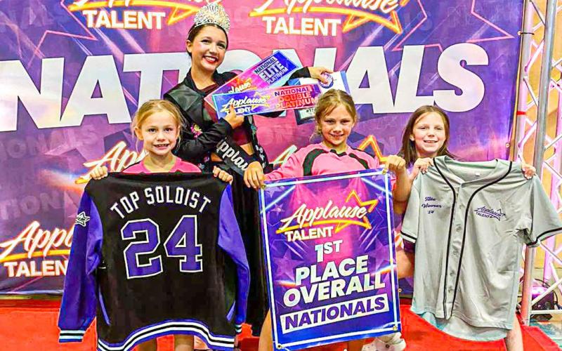THEY’RE ALL THAT. Pictured from left to right: Leni Flora, Sara Smith, Baylee Flora and Candace Carey hold up the awards that All That Jazz Dance Studio racked up at the Applause Talent Nationals competition. Photo via All That Jazz Facebook Article Image Alt Text