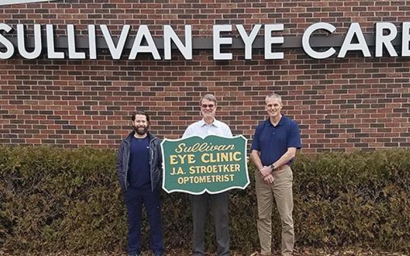 From left to right, Jason Riley, O.D., Joseph Stroetker, O.D., David Prange, O.D. Dr. Stroetker is holding a sign from the Clark Street office location. Article Image Alt Text