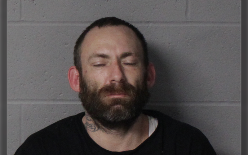 Ronald Wertenberger, mugshot, white mail, black short hair and beard; black shirt; eyes closed