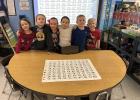 The kindergarten class proud that they were able to find 100 kisses that were hidden in their room.