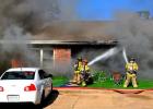 Firefighters extinguish the flames at an apartment building located on East Vine Street. Photo by James Johnson Article Image Alt Text