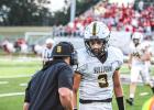 COMMANDERS-IN-CHIEF. Head coach Eddie Haar gives the play call to quarterback Robert York II (3) in their battle against St. Clair on Sep. 15. Photo by Wyatt Hardy Article Image Alt Text