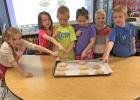 THE KINDERGARTEN STUDENTS from Strain-Japan pointing out their own loaves of bread ready to rise.