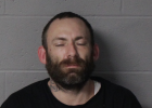 Ronald Wertenberger, mugshot, white mail, black short hair and beard; black shirt; eyes closed